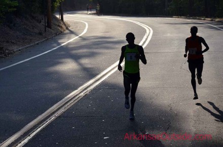 Race leaders taking a commanding lead on the pack in the early morning light.