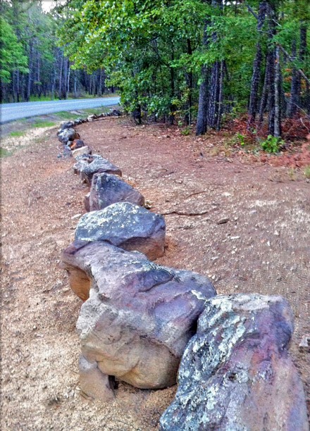 When entering or exiting the trail, stay on the wood side of these rocks.
