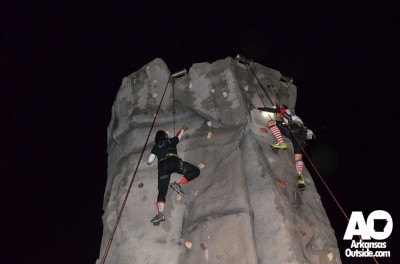 A couple of climbers racing for the top in the rain.