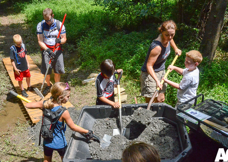 Showing the kids how the business end of a shovel works during a recent trail work day.