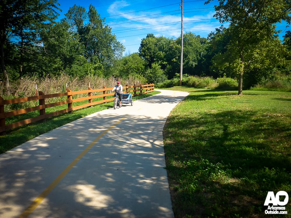 Mom pulling her child along the Greenway.